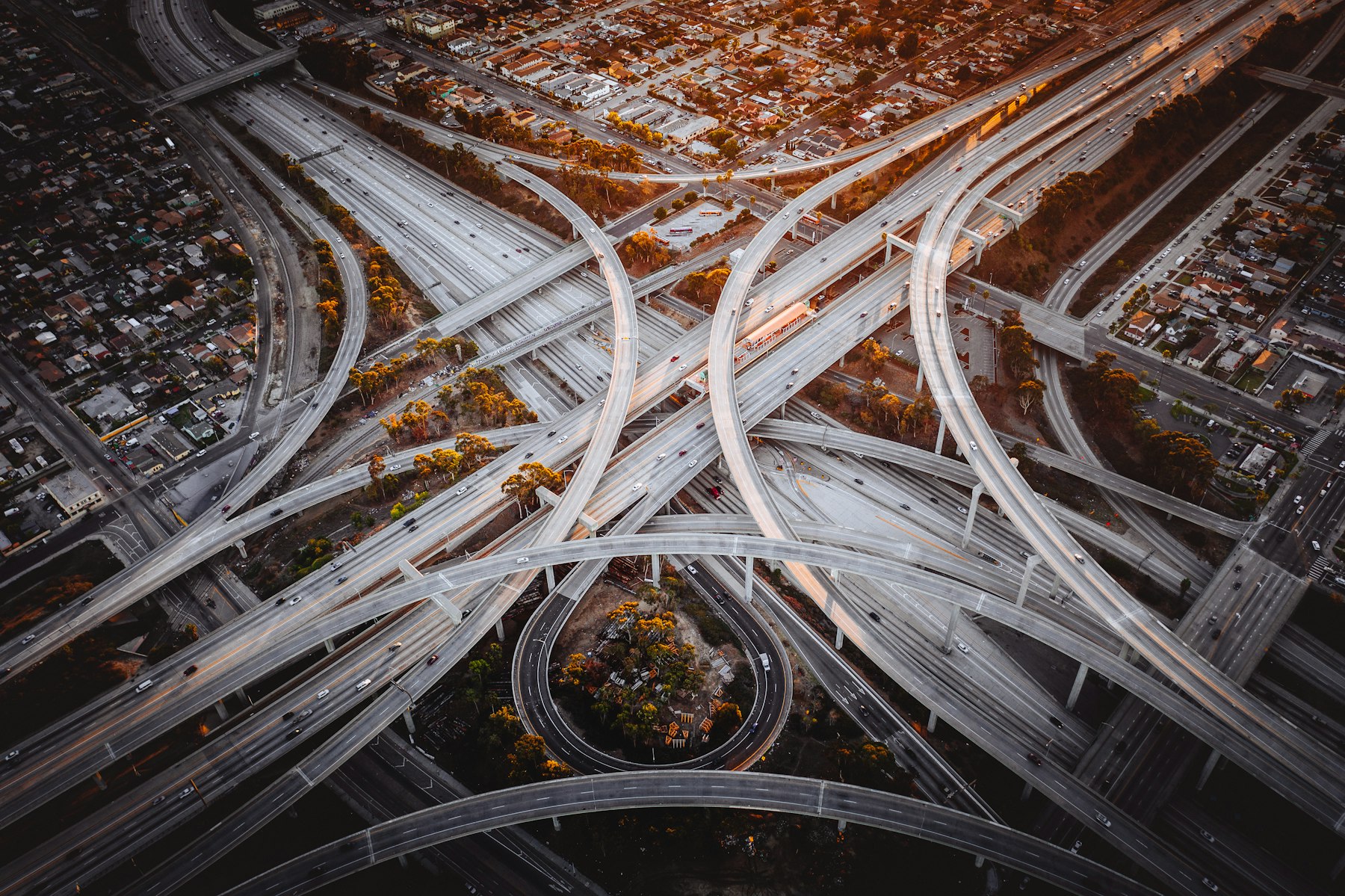 Aerial view of a multi-level urban highway interchange at sunset